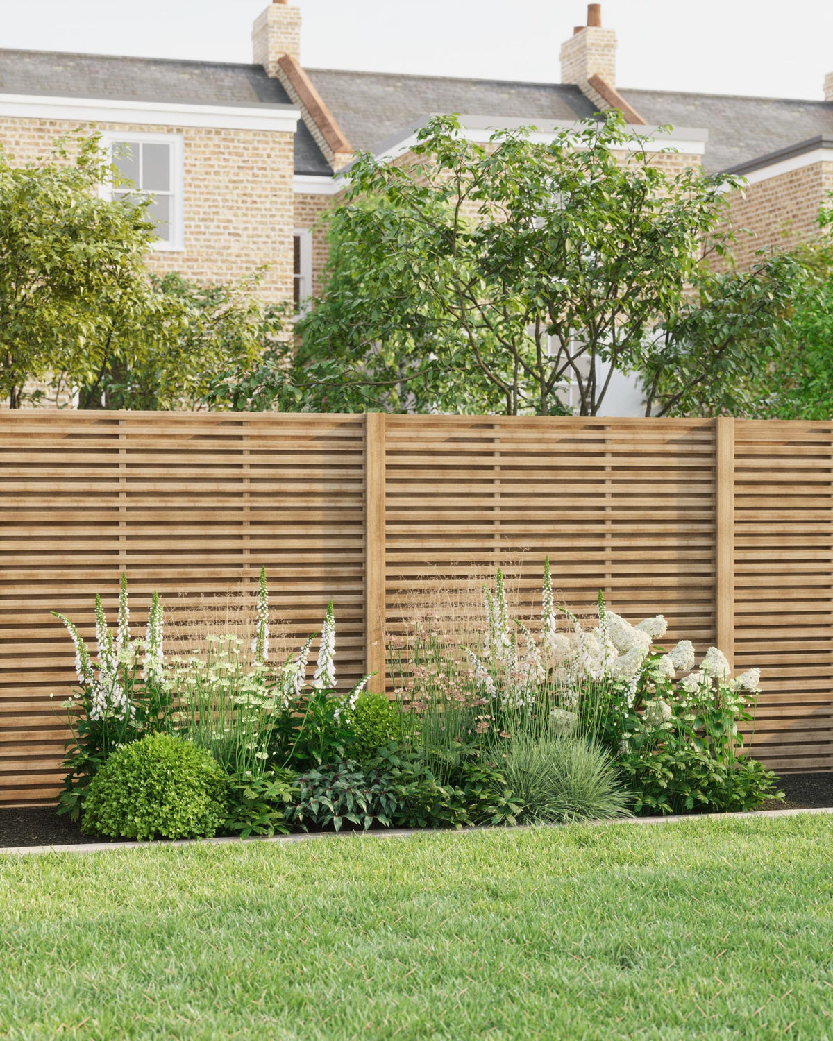 A Soto White border planted against a slatted timber fence