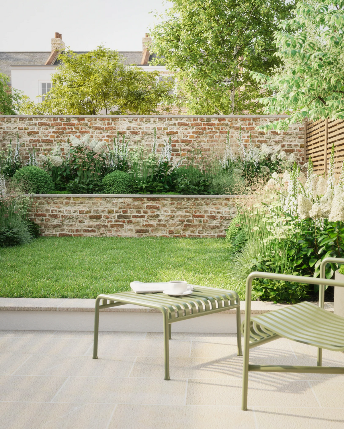 A Soto White border planted against a slatted timber fence